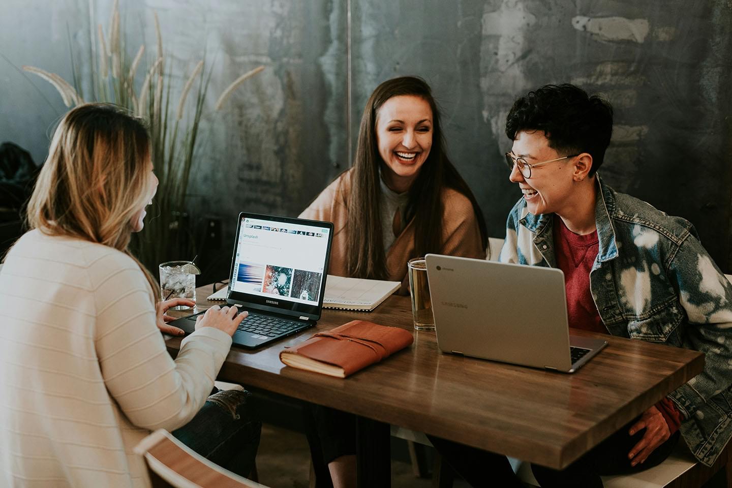 Group of friends working together on laptops